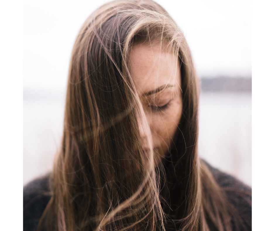 Adult woman representing the emotional and internal factors associated with persistent adult acne and skin imbalance